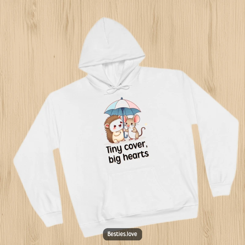 Funny hoodie with a shy hedgehog and a brave mouse huddled close under an extremely small umbrella, symbolizing unity and courage.