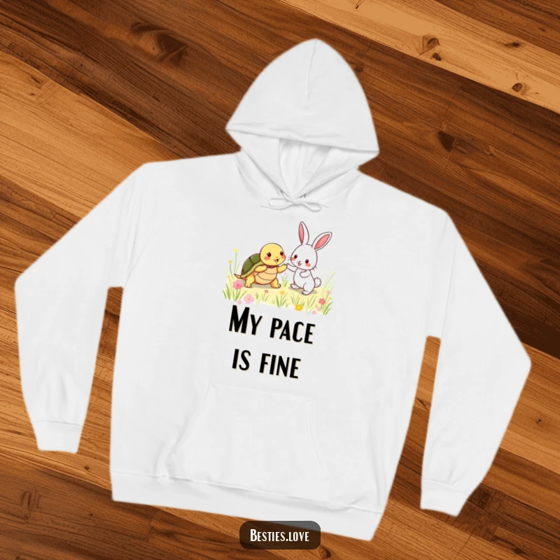 Funny Hoodie: A shy turtle and an energetic rabbit chasing each other in a meadow, a humorous and heartwarming scene of friendship.